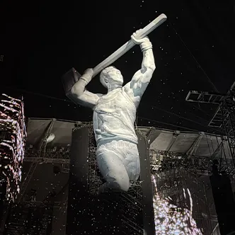 Giant illuminated performer figure inflatable on night concert stage