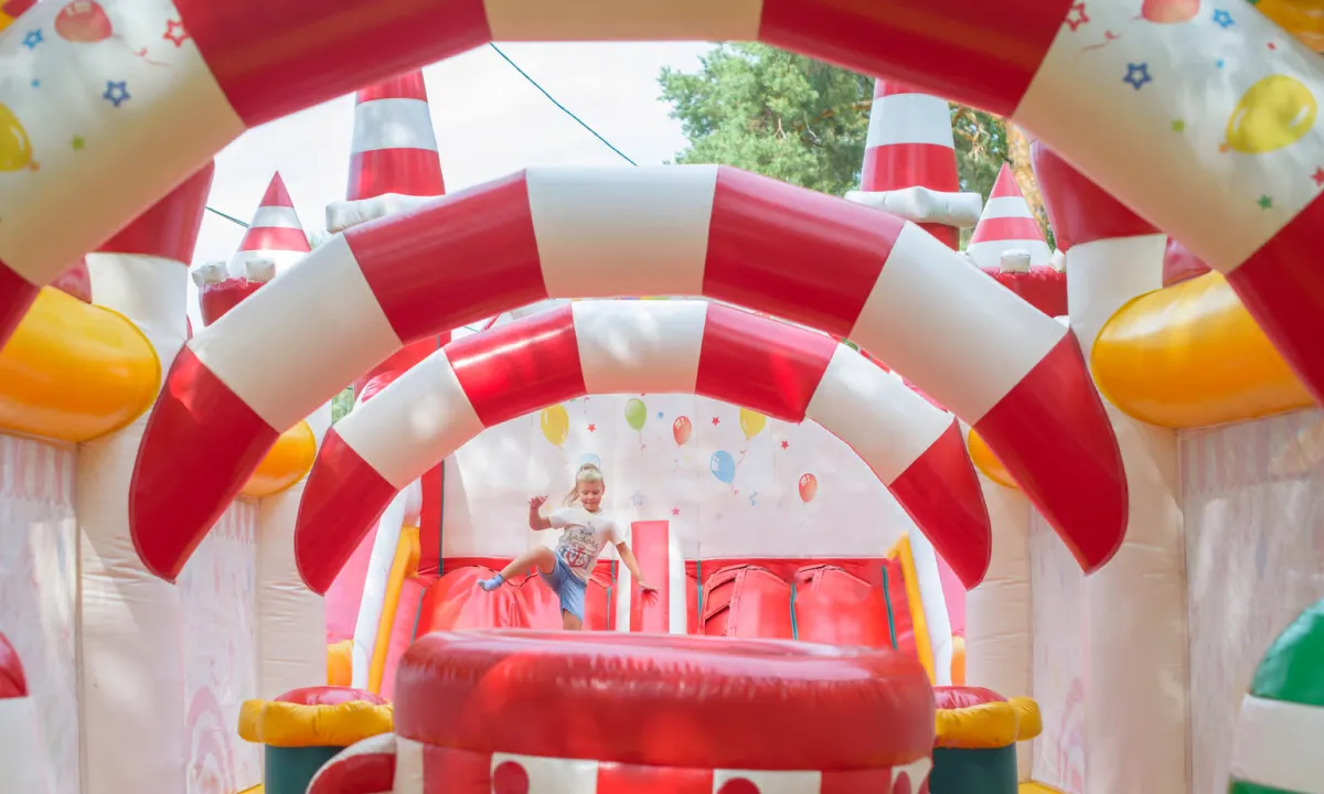 13 x 13 ft commercial combo bounce house with slide set up for a backyard birthday party